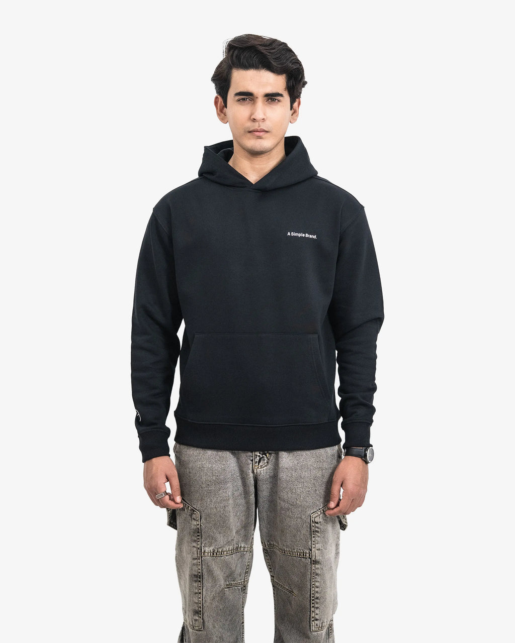 Person wearing a black hoodie with a brand logo on a white background
