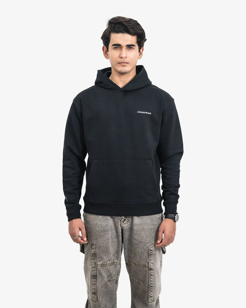 Person wearing a black hoodie with a brand logo on a white background
