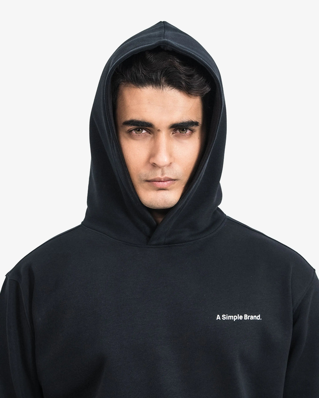 Man wearing a black hoodie with 'A Simple Brand' logo on a white background