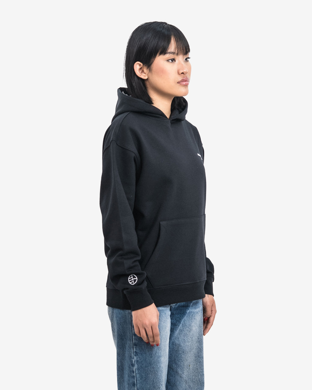 Person wearing a black hoodie with a logo on a white background