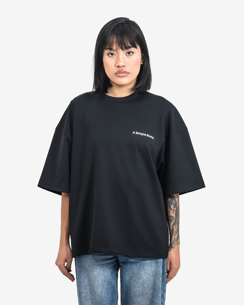 Person wearing a black t-shirt with text on a white background