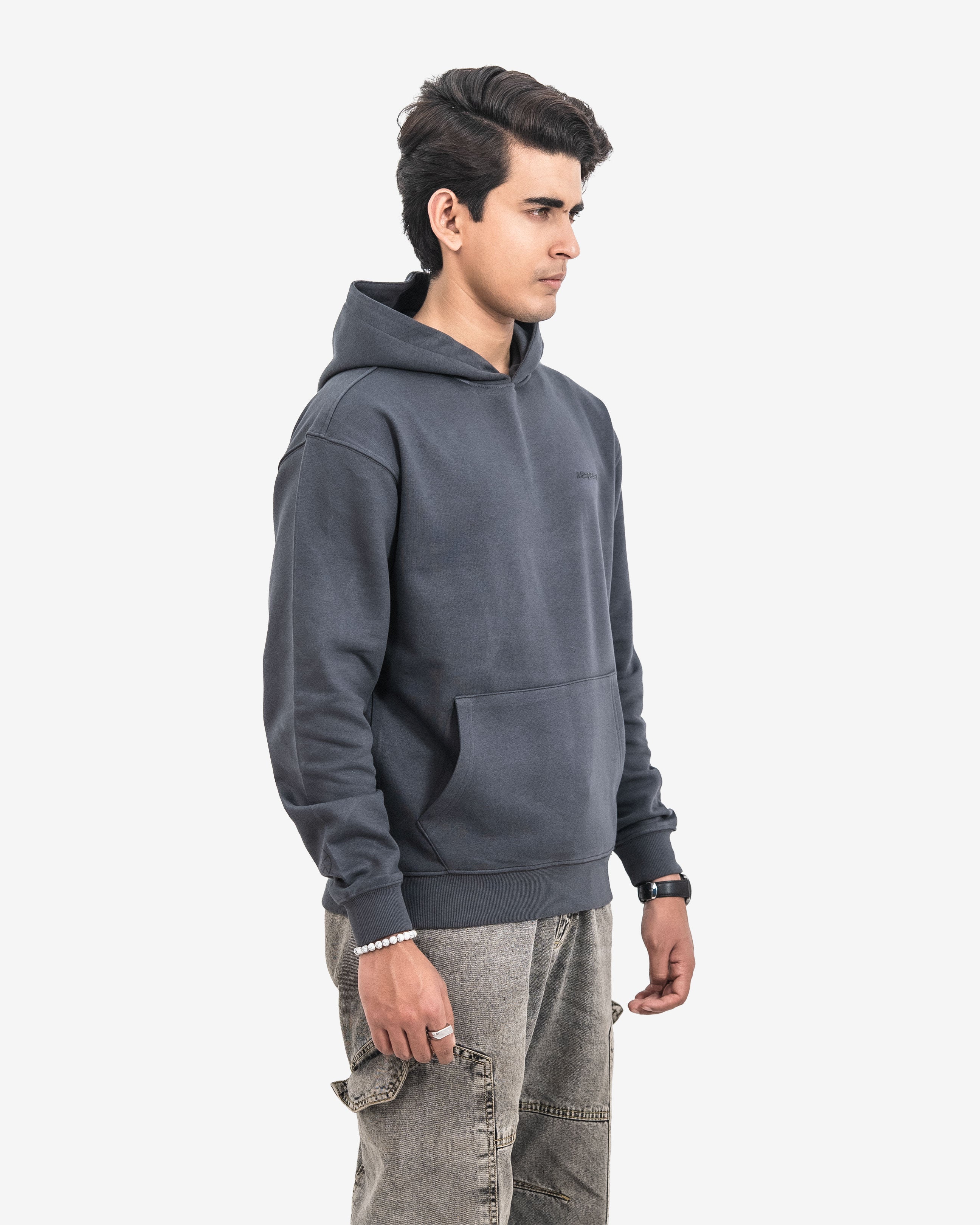 Person wearing a dark gray hoodie on a white background